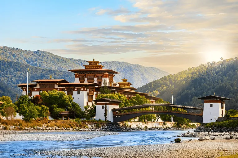 Evening sun on the white walls of Punakha Dzong above the blue Mo Chhu river